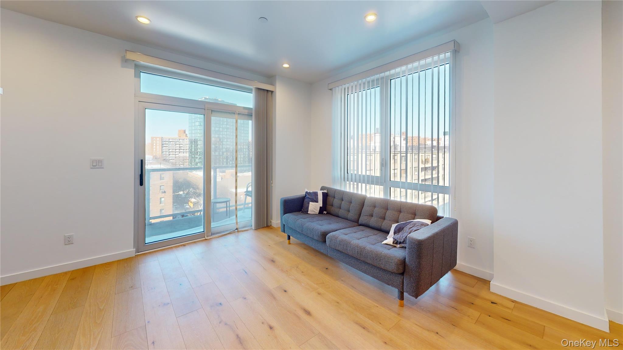 97-29 64th Road Queens, NY 11374 - Photo 5 of 11 a living room with furniture and a large window