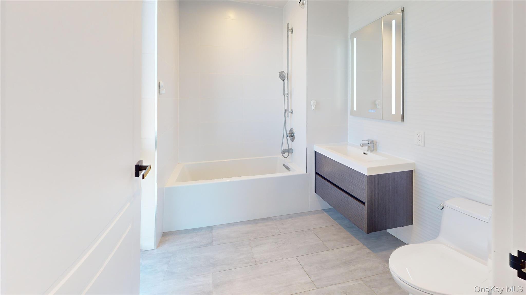 97-29 64th Road Queens, NY 11374 - Photo 10 of 11 a bathroom with a bathtub sink and toilet