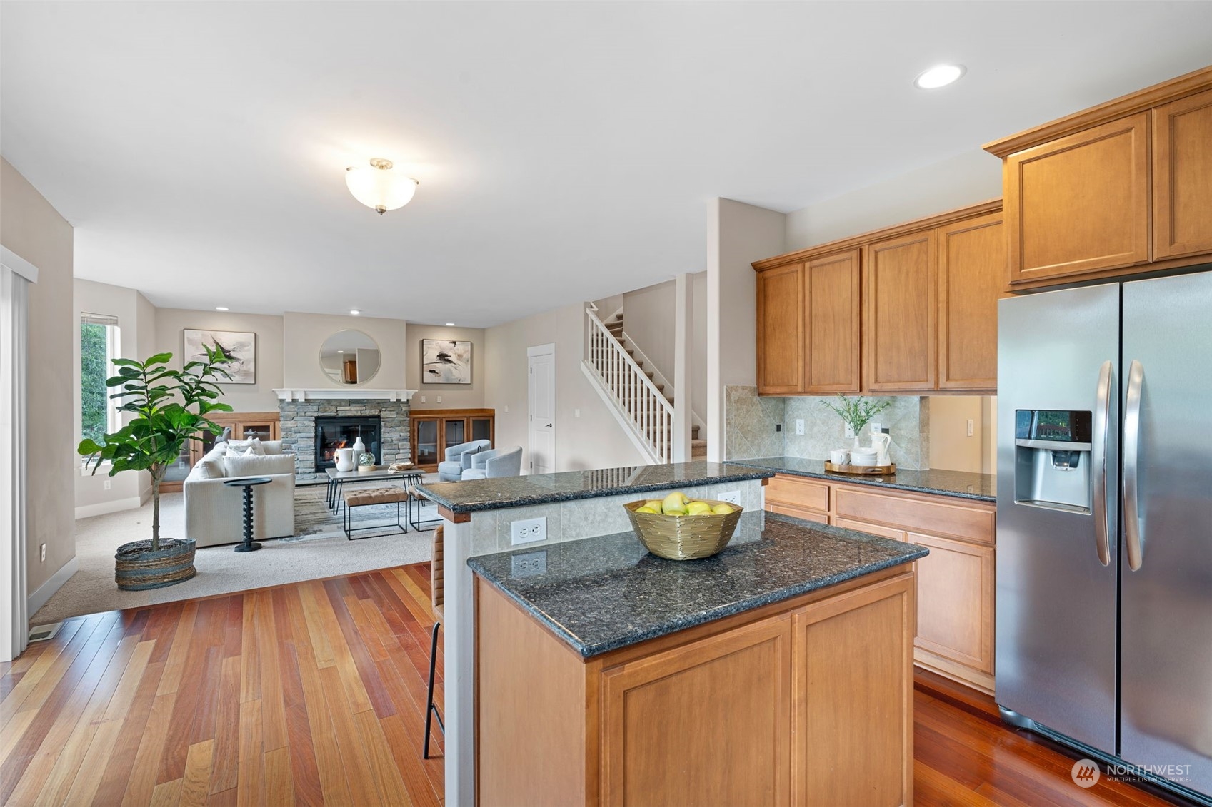 906 Jericho Place Northeast Renton, WA 98059 - Photo 14 of 39 a kitchen with a wooden floor and a refrigerator