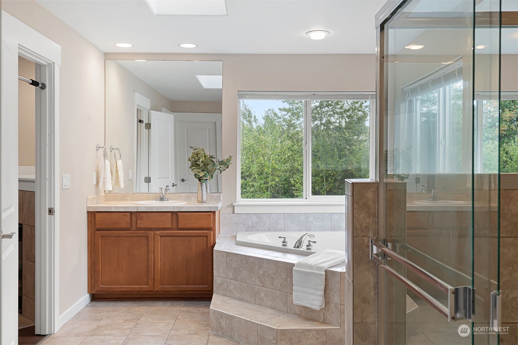 906 Jericho Place Northeast Renton, WA 98059 - Photo 23 of 39 a bathroom with a tub sink shower and mirror
