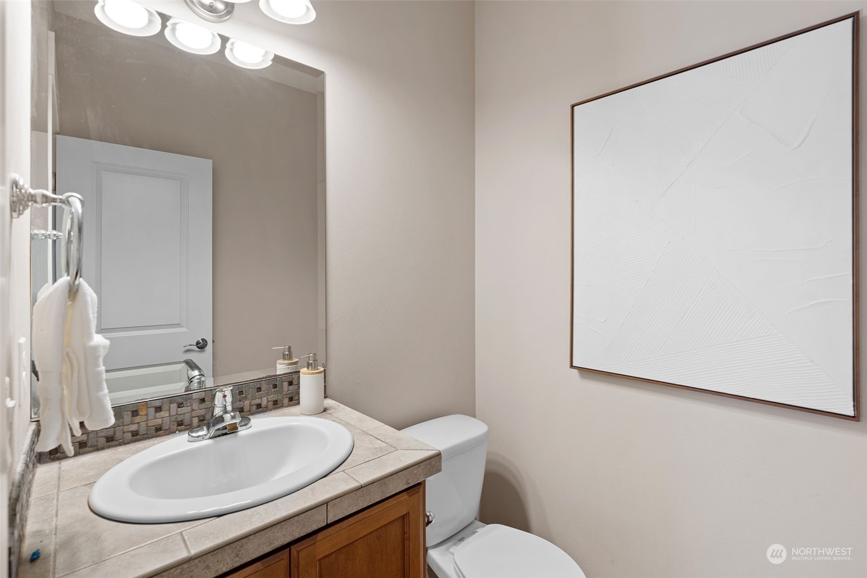 906 Jericho Place Northeast Renton, WA 98059 - Photo 5 of 39 a bathroom with a sink vanity mirror and toilet