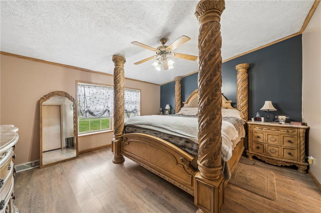 275 Adamik Road Clarksville, PA 15322 - Photo 7 of 39 a bedroom with a bed and a chandelier