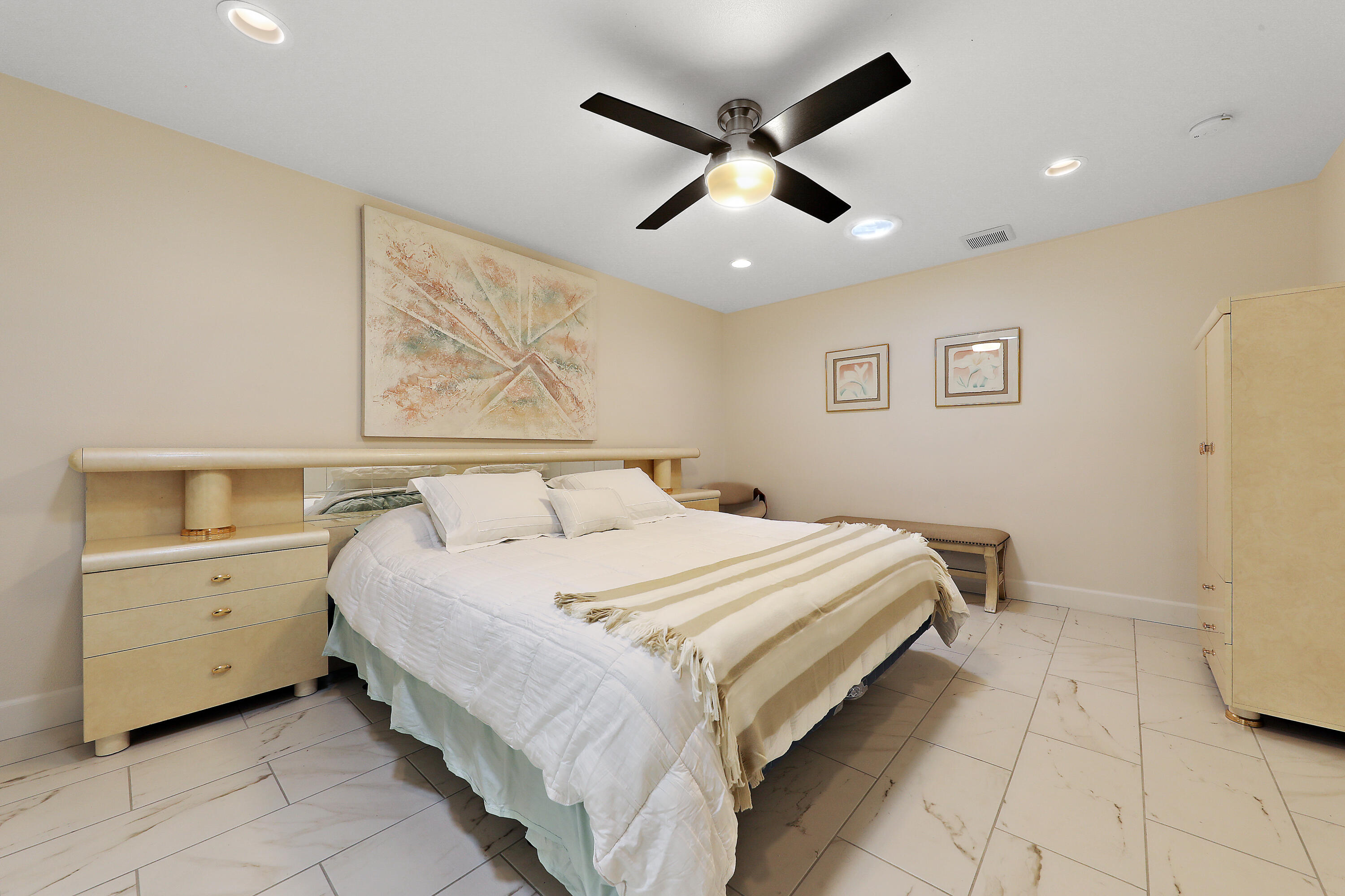 159 Torremolinos Drive Rancho Mirage, CA 92270 - Photo 12 of 17 a bedroom with a large bed and a chandelier