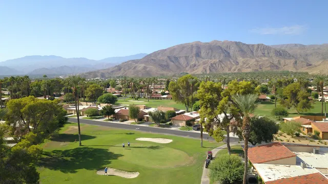 a view of a town with mountains in the background