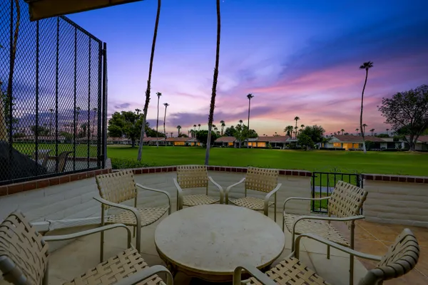 a view of a chairs and table in the patio