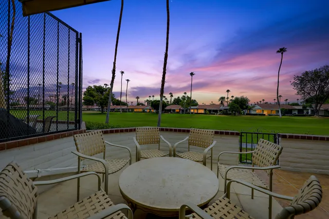 a view of a chairs and table in the patio