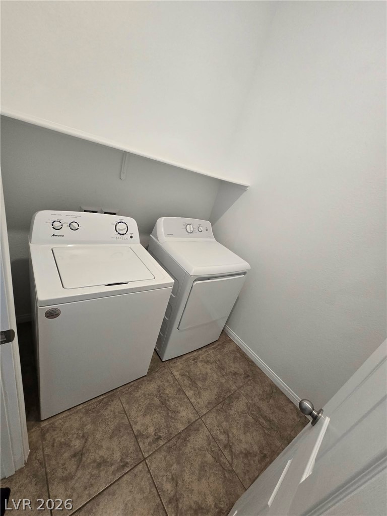 4748 Ritual Street North Las Vegas, NV 89031 - Photo 30 of 31 Functional laundry nook with tiled flooring provides practical utility.