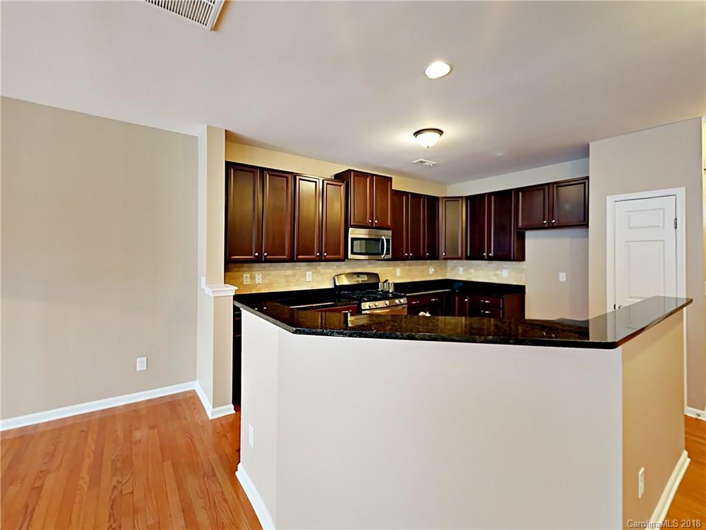 813 Kimbrough Court Davidson, NC 28036 - Photo 4 of 22 a kitchen with granite countertop a sink and a stove top oven