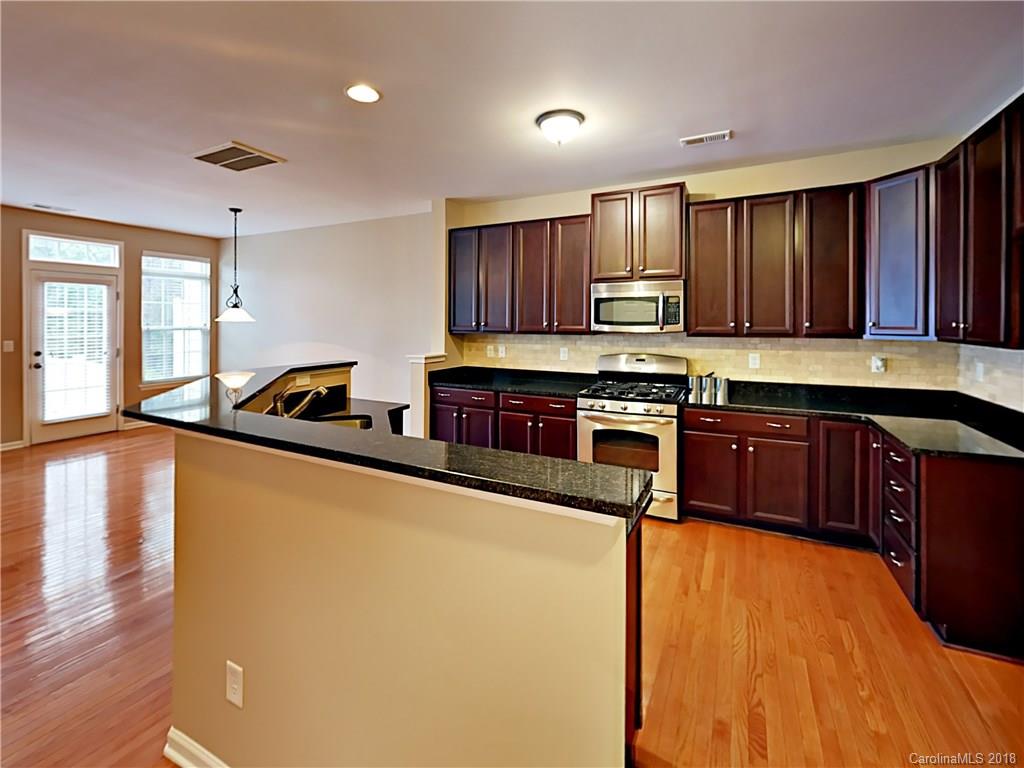 813 Kimbrough Court Davidson, NC 28036 - Photo 5 of 22 a kitchen with stainless steel appliances granite countertop a stove a sink and a refrigerator