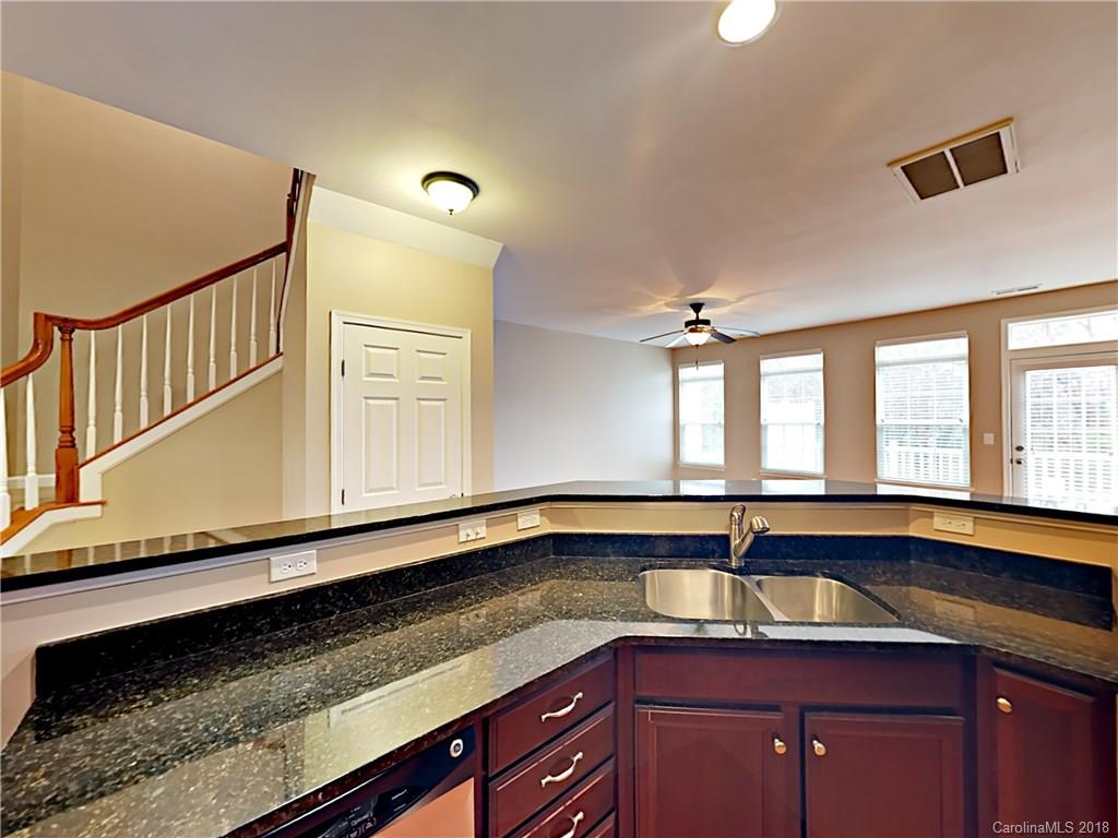 813 Kimbrough Court Davidson, NC 28036 - Photo 7 of 22 a kitchen with granite countertop sink and cabinets