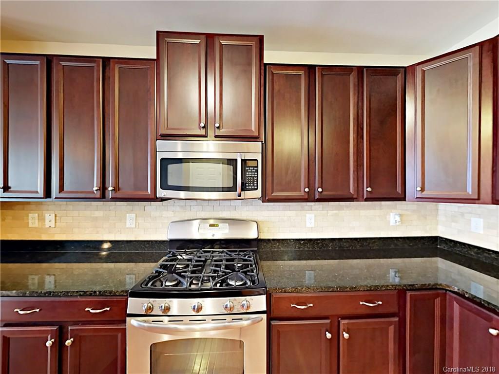 813 Kimbrough Court Davidson, NC 28036 - Photo 8 of 22 a kitchen with granite countertop cabinets and steel stainless steel appliances