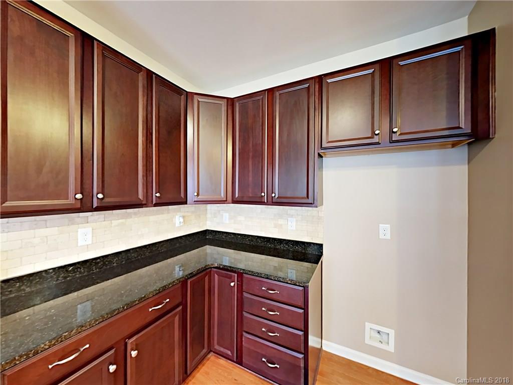 813 Kimbrough Court Davidson, NC 28036 - Photo 9 of 22 a kitchen with wooden cabinets and a sink