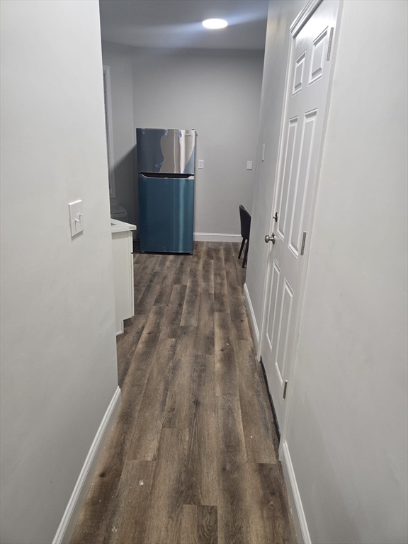 304 Warren Street, Unit 3L Boston, MA 02119 - Photo 1 of 9 a view of a hallway with wooden floor and staircase