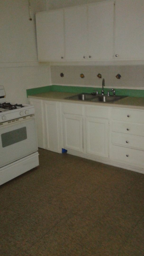 2421 North Harding Avenue, Unit 1 Chicago, IL 60647 - Photo 11 of 14 a kitchen with white cabinets and a stove