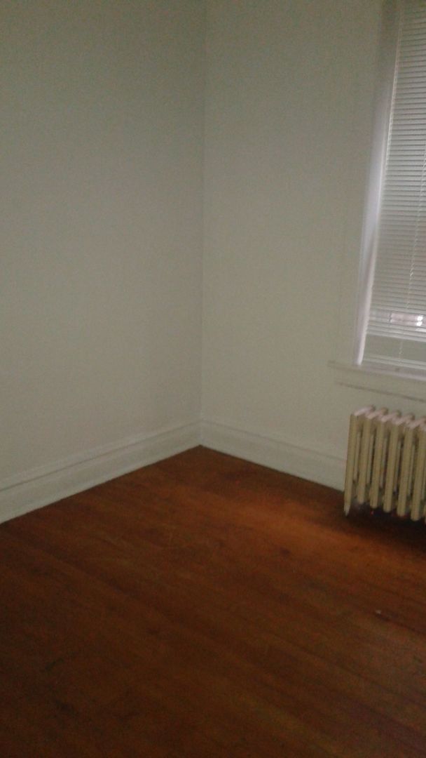 2421 North Harding Avenue, Unit 1 Chicago, IL 60647 - Photo 12 of 14 a view of an empty room with wooden floor and a window