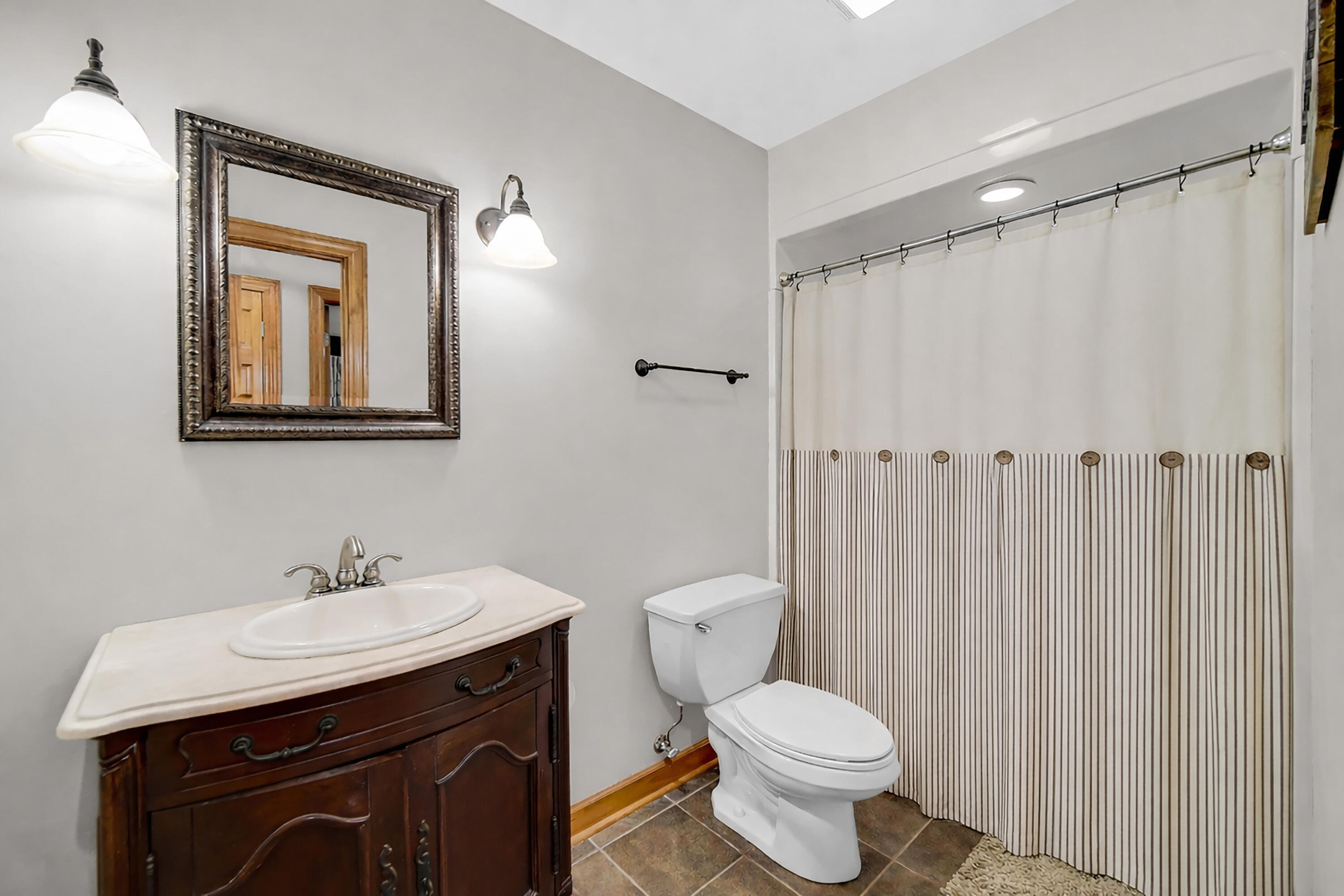 1750 West 174th Place Lowell, IN 46356 - Photo 20 of 23 a bathroom with a toilet sink and mirror