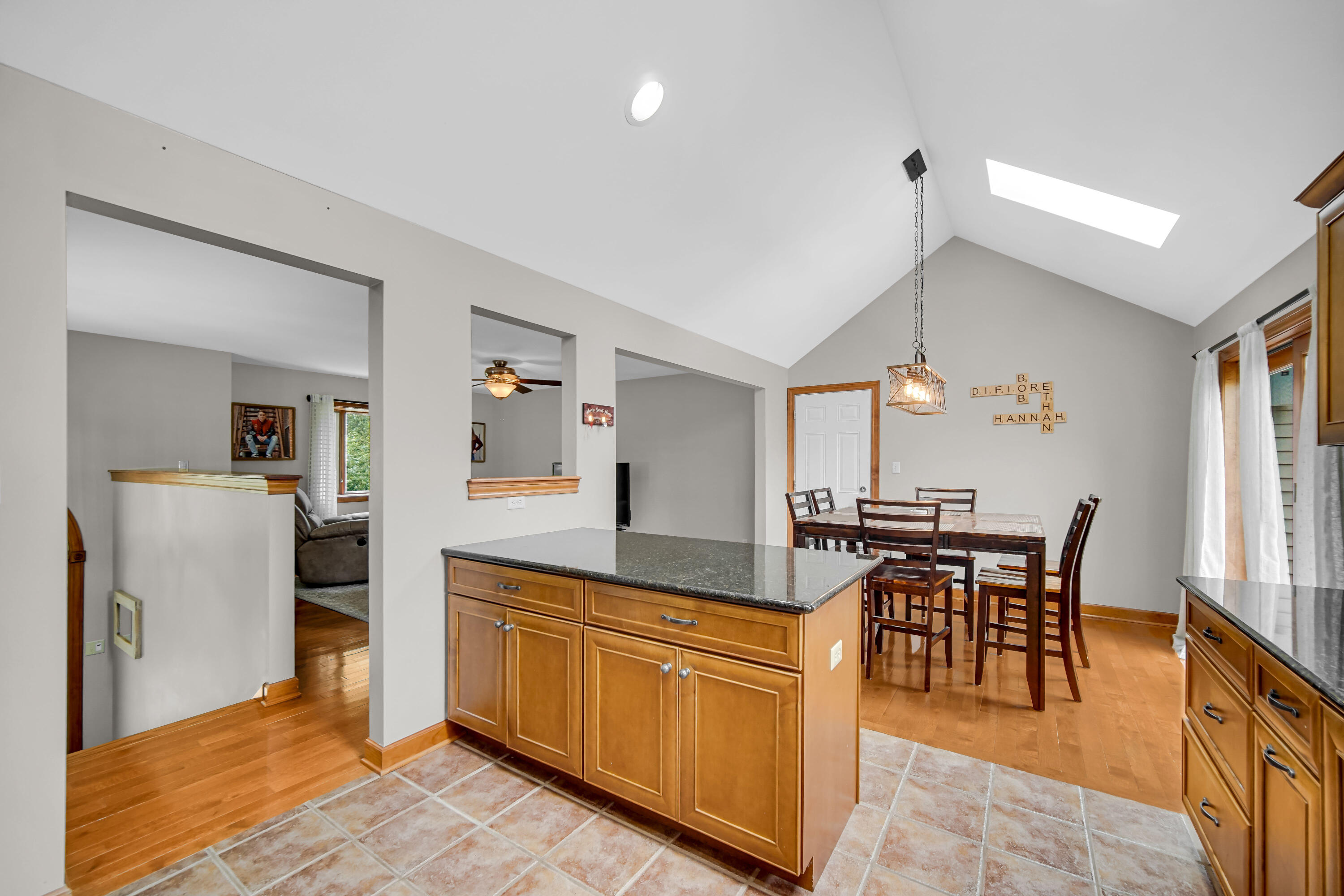 1750 West 174th Place Lowell, IN 46356 - Photo 8 of 23 a dining hall with stainless steel appliances granite countertop a stove and a dining table with wooden floor