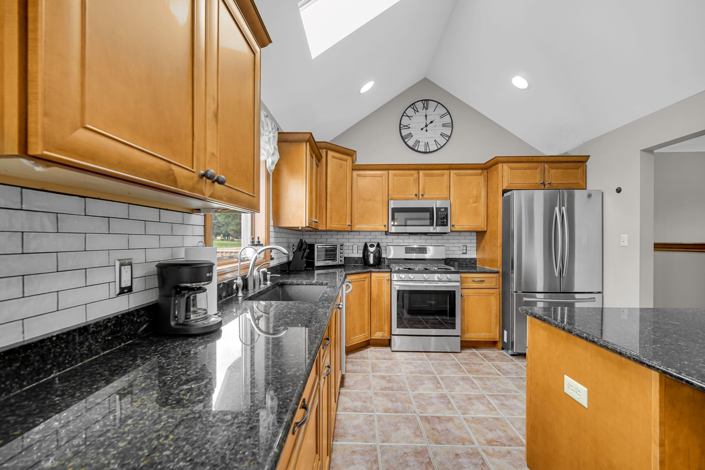 1750 West 174th Place Lowell, IN 46356 - Photo 9 of 23 a kitchen with stainless steel appliances granite countertop a stove refrigerator sink and cabinets