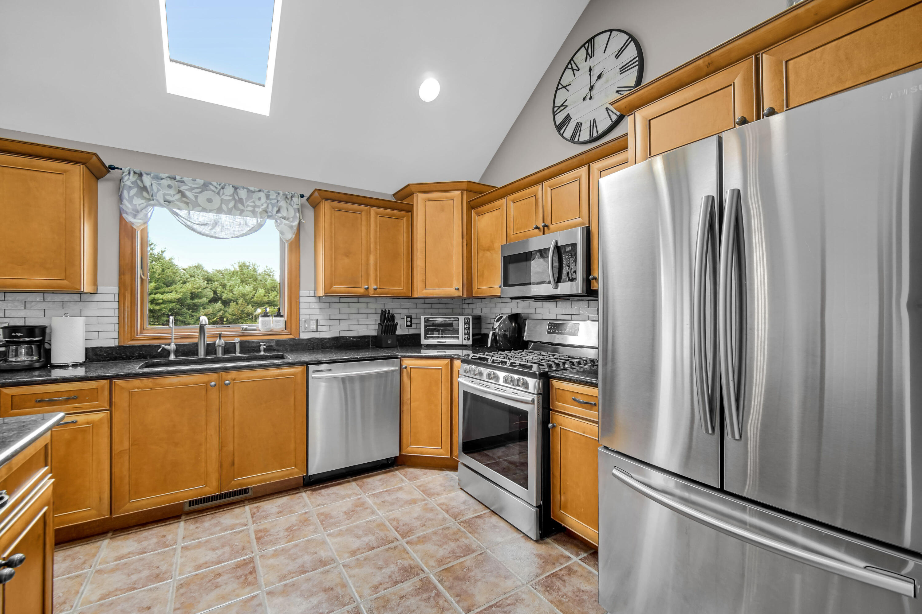1750 West 174th Place Lowell, IN 46356 - Photo 10 of 23 a kitchen with stainless steel appliances granite countertop a refrigerator a sink dishwasher a stove with wooden cabinets and floor