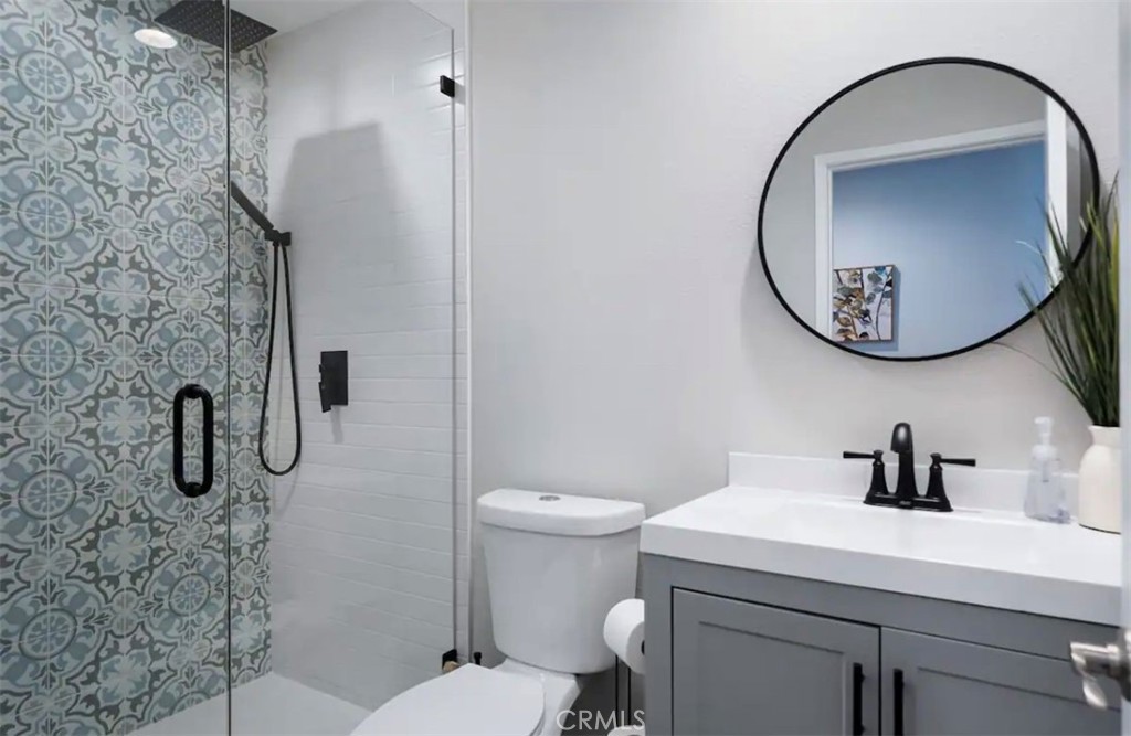 83250 Beverly Court Indio, CA 92201 - Photo 24 of 29 a bathroom with a toilet sink and mirror