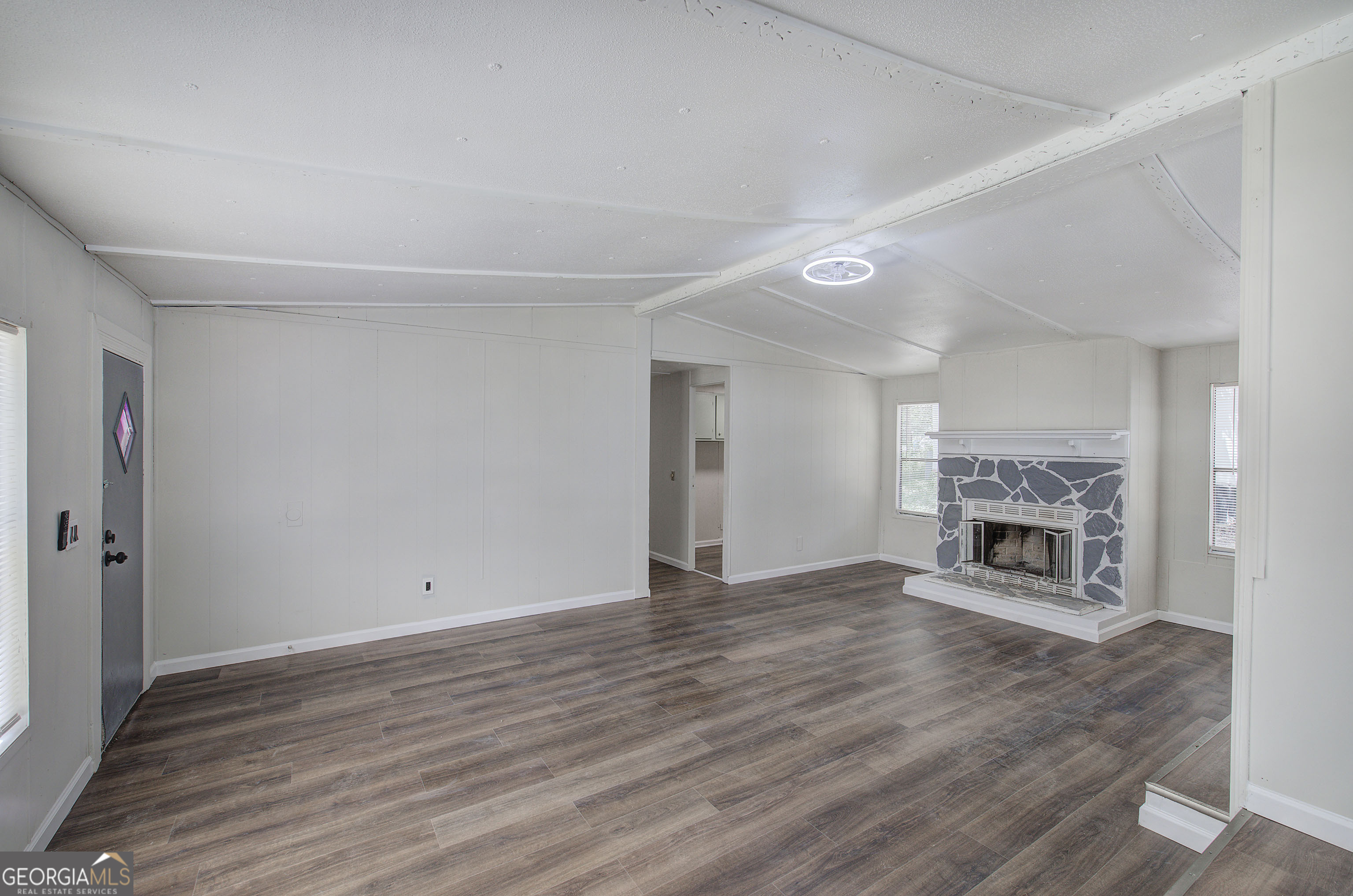264 East Big Indian Trail Northeast Rome, GA 30165 - Photo 11 of 31 a view of an empty room with wooden floor fireplace and a window