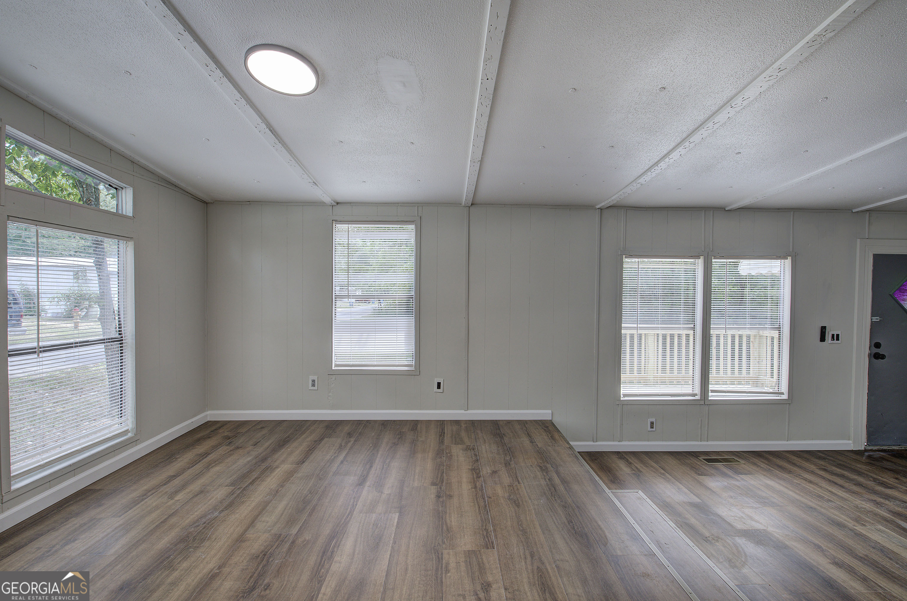 264 East Big Indian Trail Northeast Rome, GA 30165 - Photo 12 of 31 an empty room with wooden floor and windows
