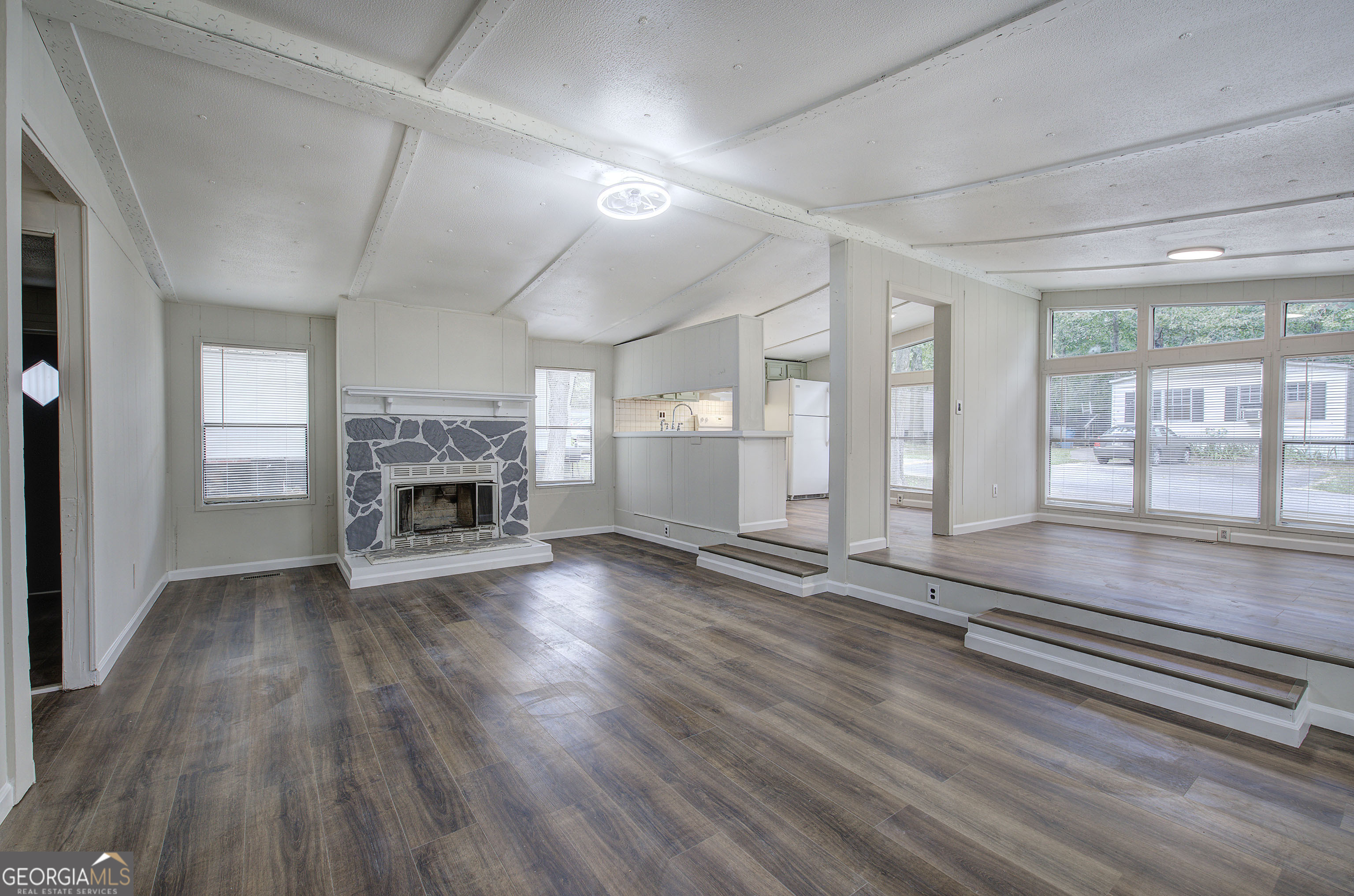 264 East Big Indian Trail Northeast Rome, GA 30165 - Photo 13 of 31 an empty room with wooden floor and fireplace