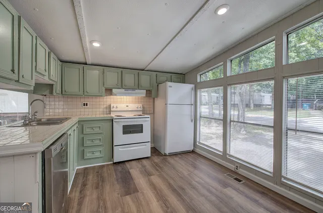 a kitchen with a stove a sink and a refrigerator