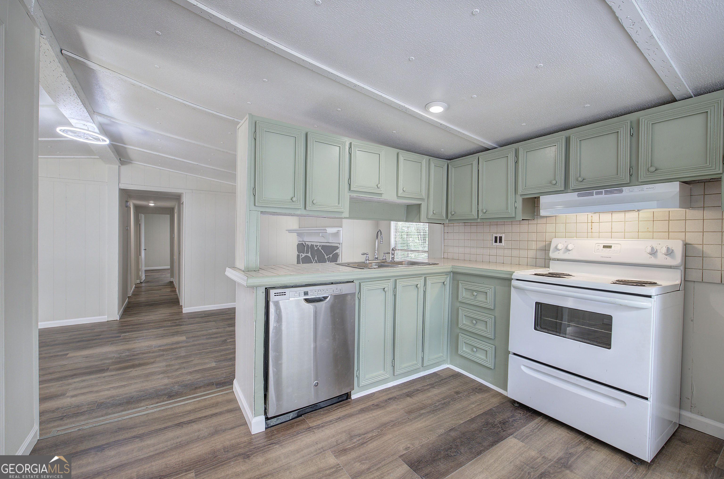 264 East Big Indian Trail Northeast Rome, GA 30165 - Photo 16 of 31 a kitchen with a stove cabinets and wooden floor