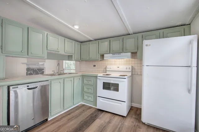 a kitchen with a white cabinets and white appliances