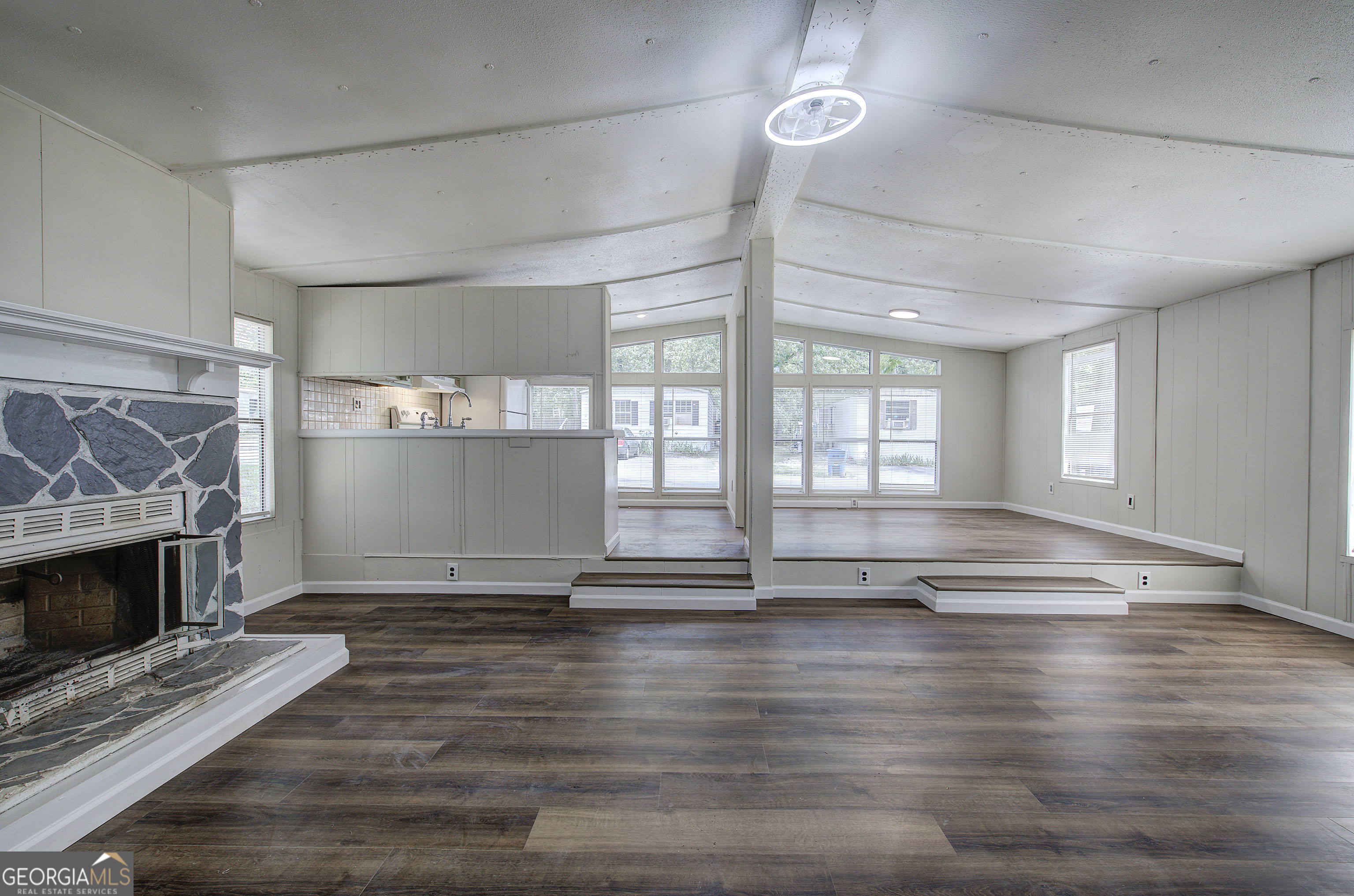 264 East Big Indian Trail Northeast Rome, GA 30165 - Photo 18 of 31 a view of empty room with wooden floor and fireplace