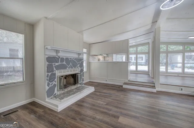 a living room with wooden floors and fireplace