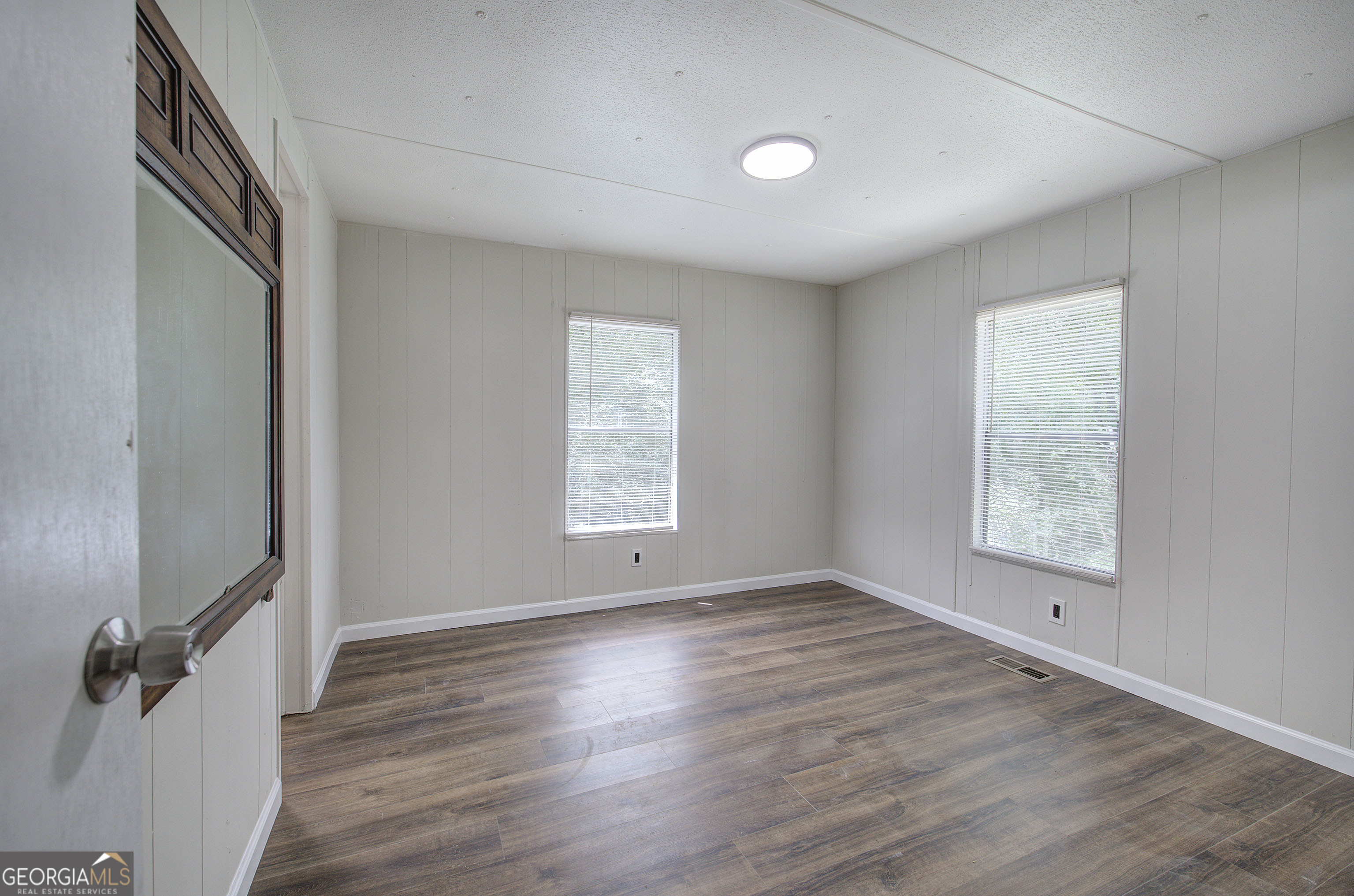 264 East Big Indian Trail Northeast Rome, GA 30165 - Photo 20 of 31 an empty room with wooden floor and windows
