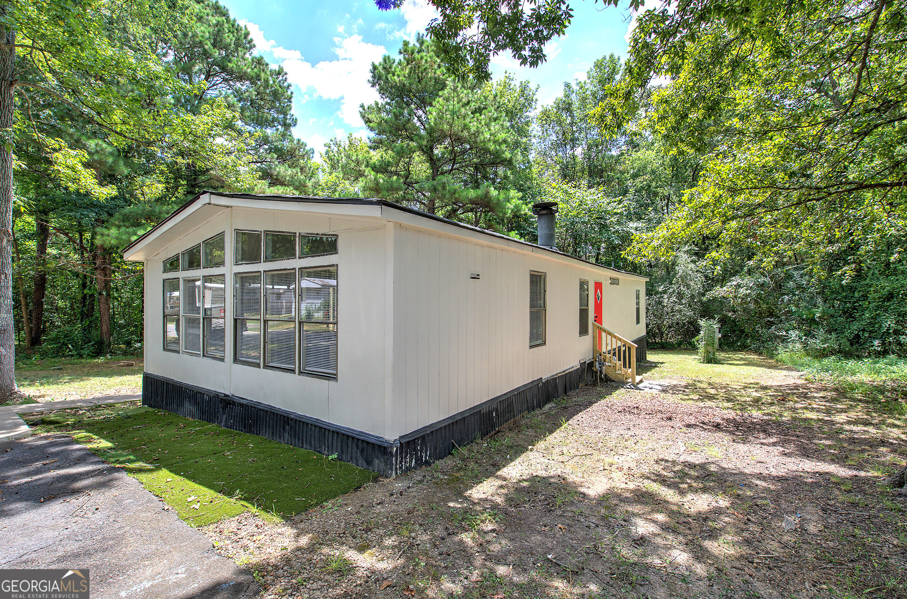 264 East Big Indian Trail Northeast Rome, GA 30165 - Photo 2 of 31 a view of a small house with a yard and large trees