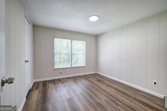 wooden floor in an empty room with a window