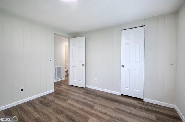 a view of an empty room and wooden floor