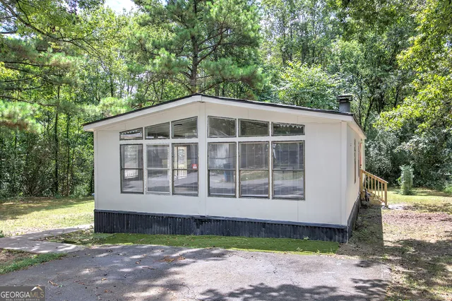 a front view of a house with a garden