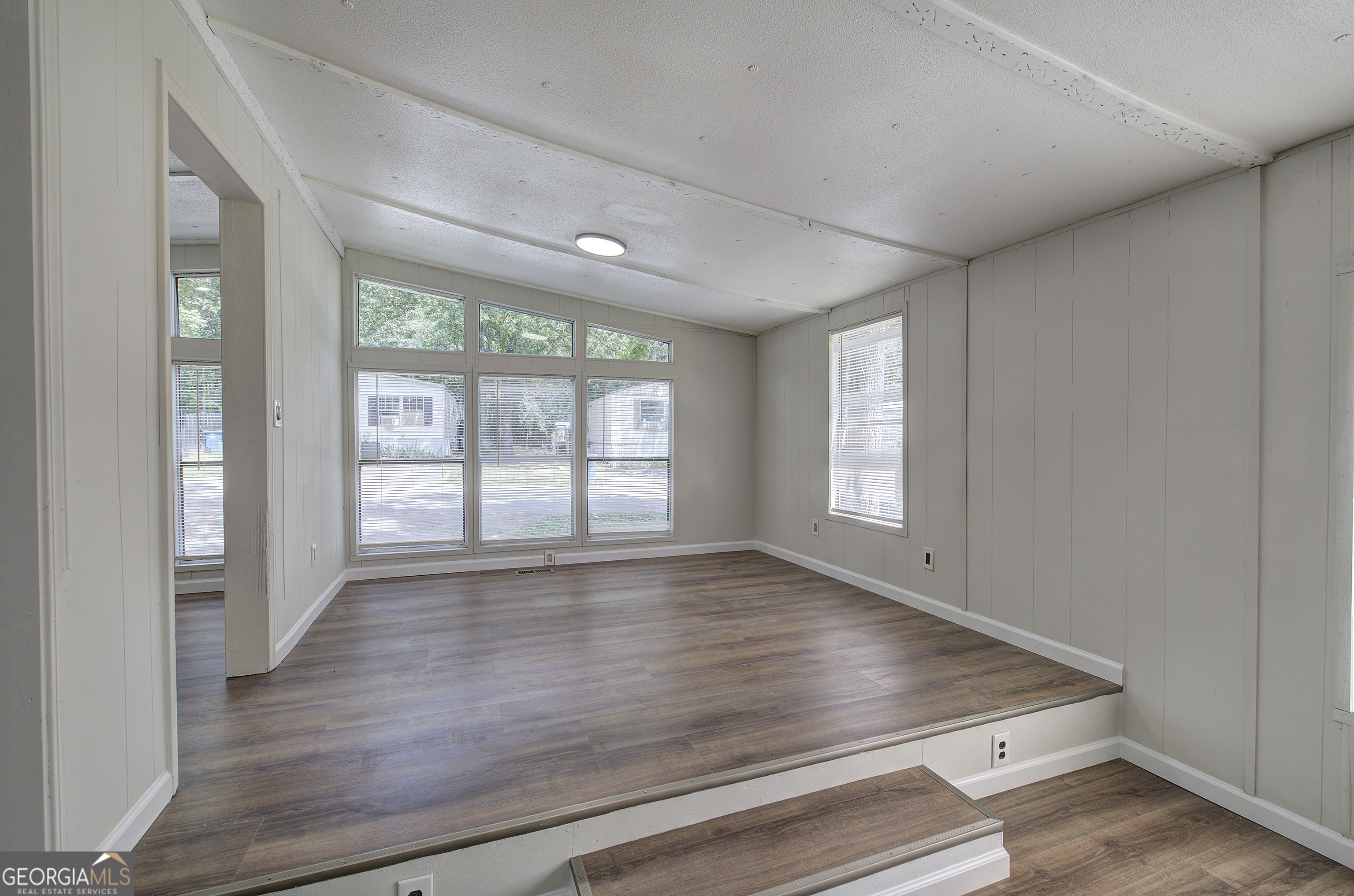 264 East Big Indian Trail Northeast Rome, GA 30165 - Photo 9 of 31 a view of an empty room with wooden floor and a window