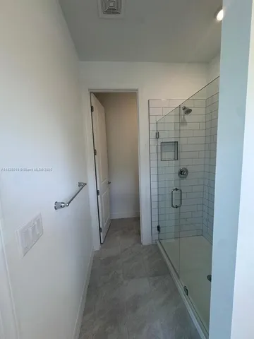 a bathroom with a shower and a tub