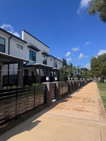 a view of a house with a wooden fence