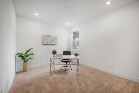 a workspace with furniture and a potted plant