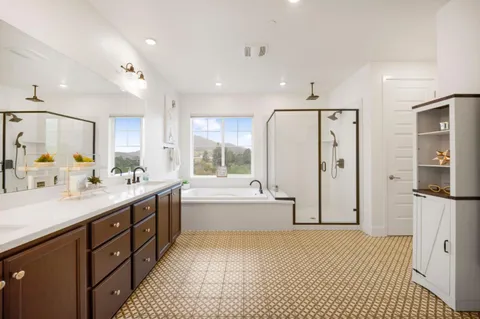 a large bathroom with a double vanity sink a large mirror and shower