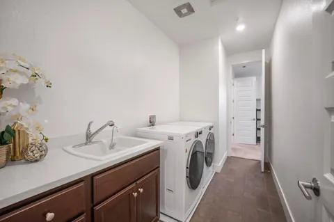 a view of a sink and washer dryer