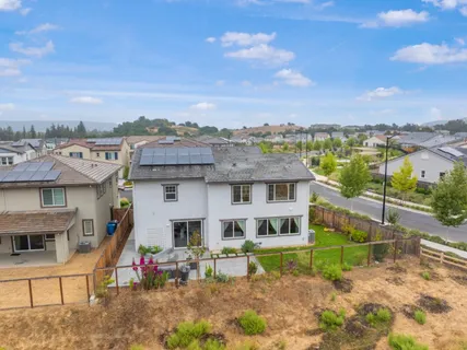 an aerial view of a house with a yard