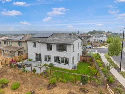 an aerial view of a house with a big yard and potted plants