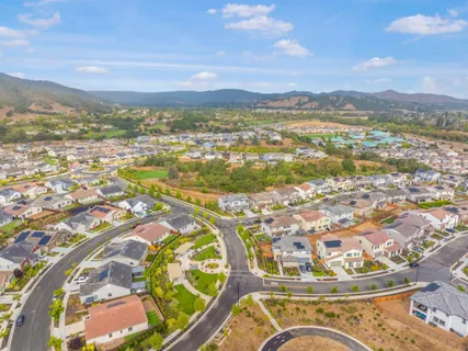 an aerial view of residential houses with outdoor space