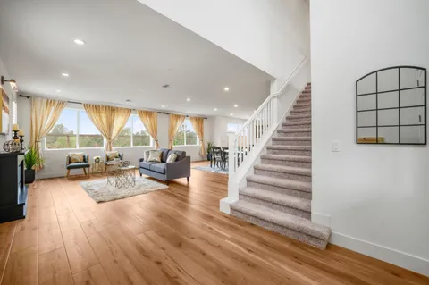 a view of a living room and entryway with wooden floor
