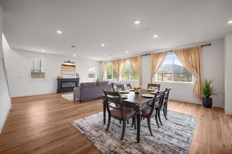 a view of a dining room with furniture window and wooden floor