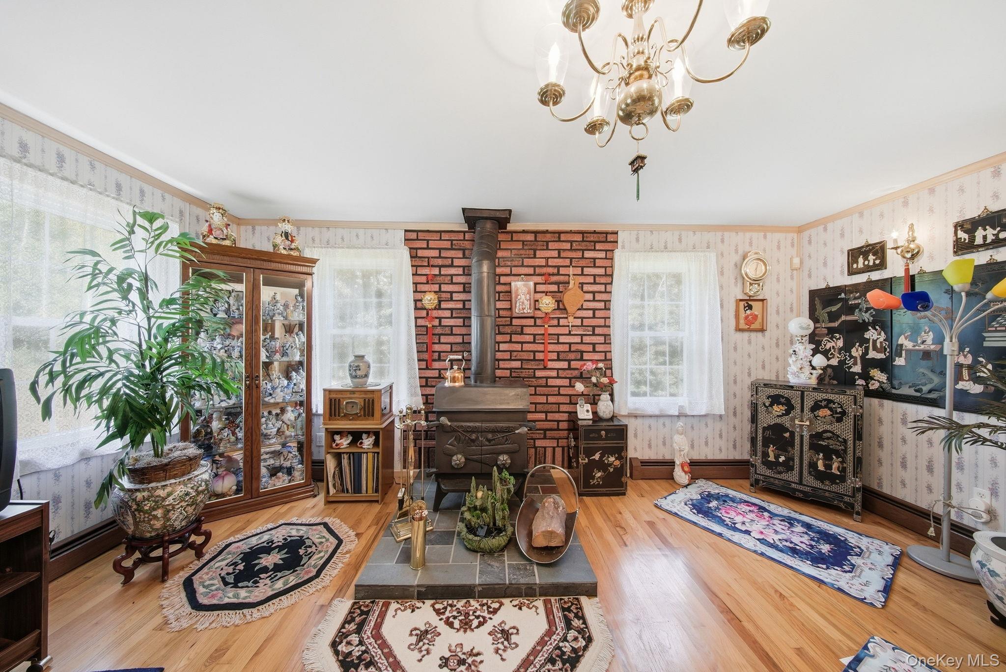 10 Hoffman Road Hankins, NY 12741 - Photo 9 of 46 Living room with hardwood floors, wood burning stove and lots of natural light