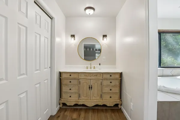 a bathroom with a sink a vanity and a mirror